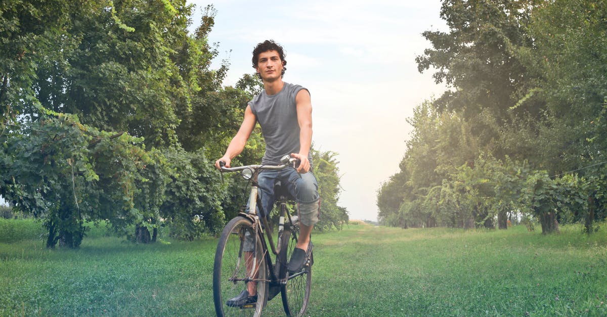 With which countries does Canada have reciprocal health agreements? - Man in Gray Sleeveless Shirt Riding Bike