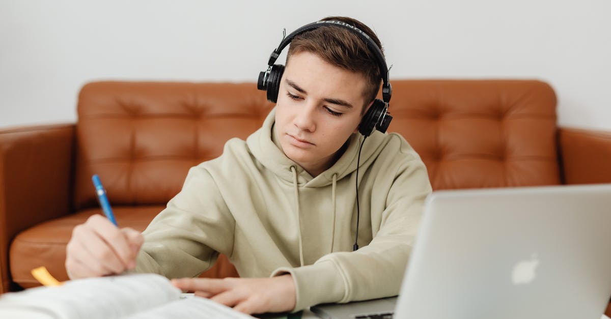 Working and Studying in Russia [closed] - Photo of a Boy Doing His Homework while Listening to Music