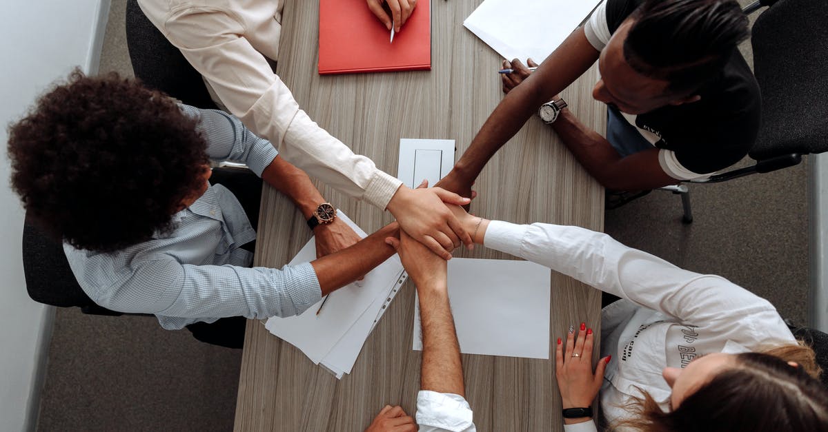 Working on eTA for a non-Canadian company - Coworkers with Their Hands Together