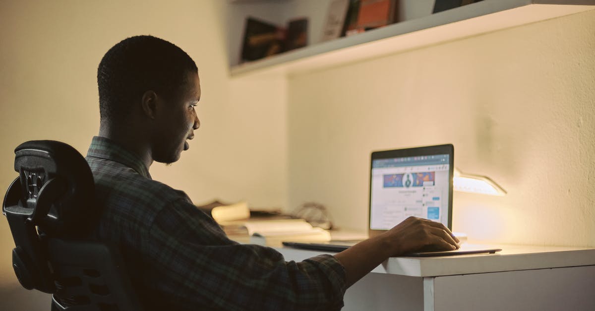 Working remotely from another EU country [duplicate] - Man in Black and Gray Plaid Dress Shirt Using Macbook Pro