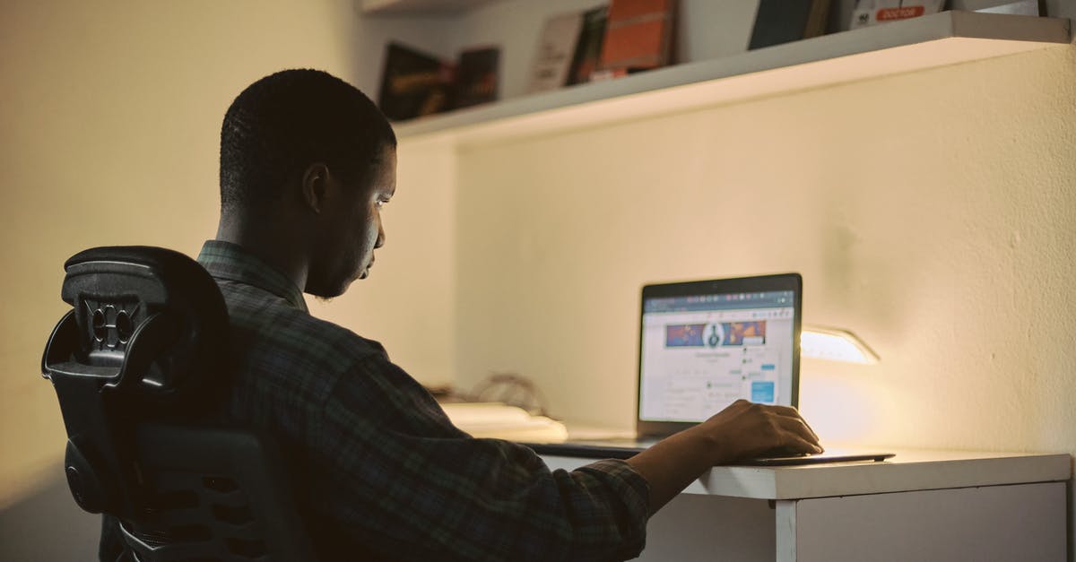 Working remotely from another EU country [duplicate] - Man in Black and White Plaid Dress Shirt Using Macbook Pro