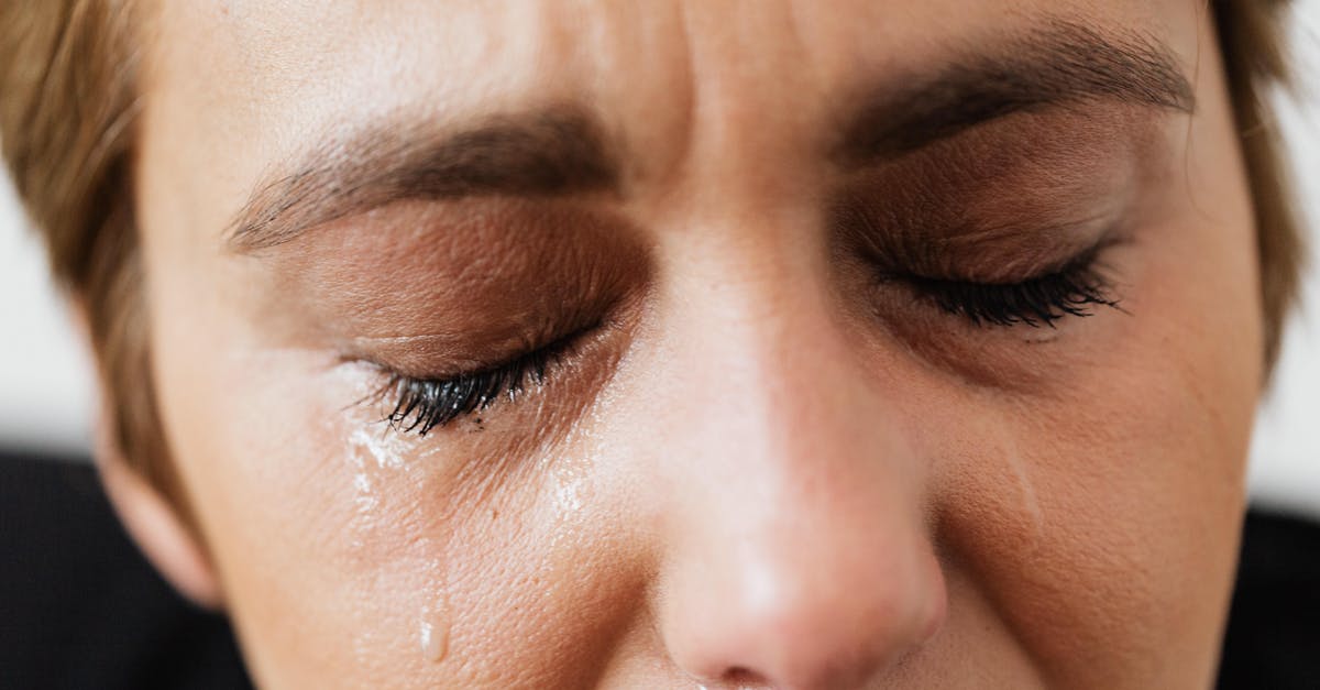 Worried about short layovers - Tears on face of crop anonymous woman