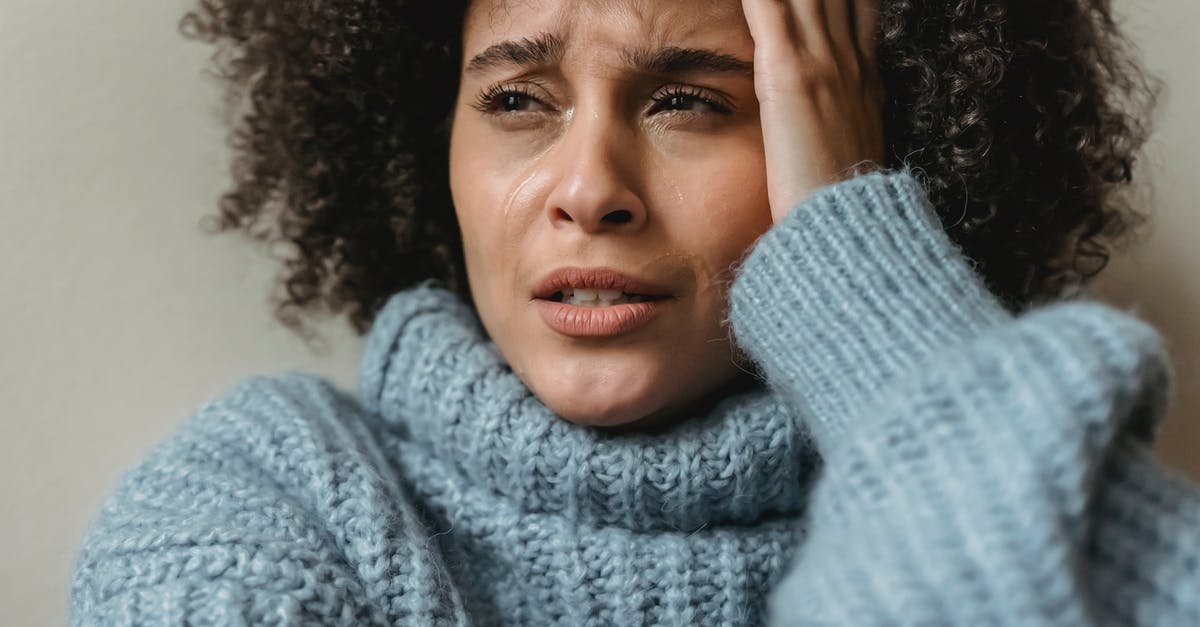 Worried about short layovers - Sad black female crying and looking away