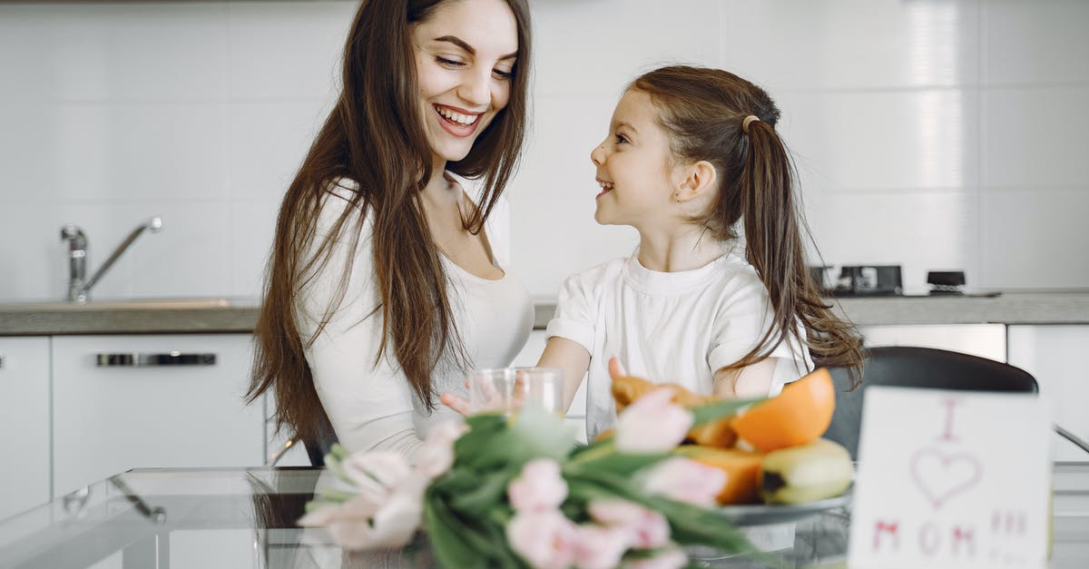 Would I be able to communicate in Vienna in German? - Happy mother and daughter enjoying morning meal in kitchen