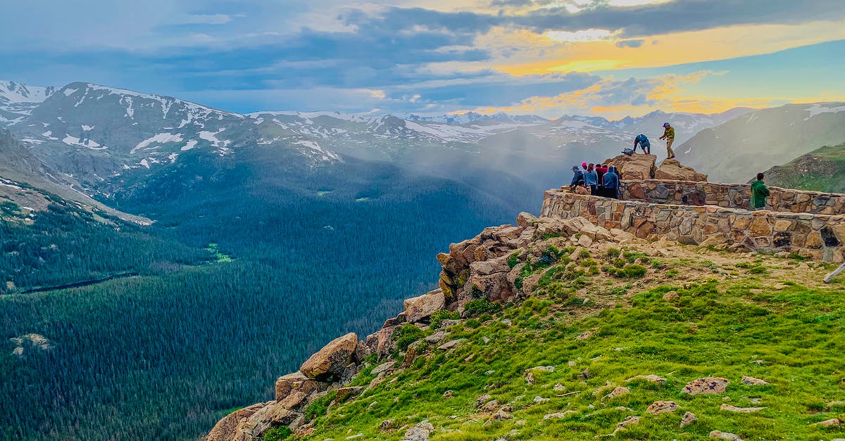 Would I be scrutinized at the border for traveling to the US twice in a quick succession? - Anonymous travelers standing on stony observation point in Forest Canyon of Rocky Mountain National Park and admiring breathtaking view during sunset in Colorado